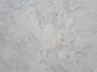 Obraz premium A close-up view of a smooth, light gray textured surface with subtle variations and patterns. The texture appears soft and uniform, ideal for backgrounds. copy space