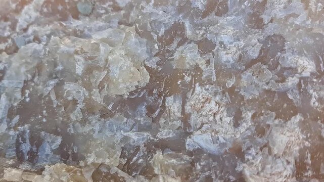 A detailed close-up of raw barite revealing each distinctive formation and texture, set in an authentic environment to emphasize the mineral's natural allure and highlight its glassy luster.
