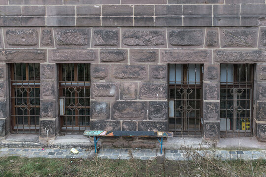 Verlassene Bank vor einer Steinmauer in N&uuml;rnberg