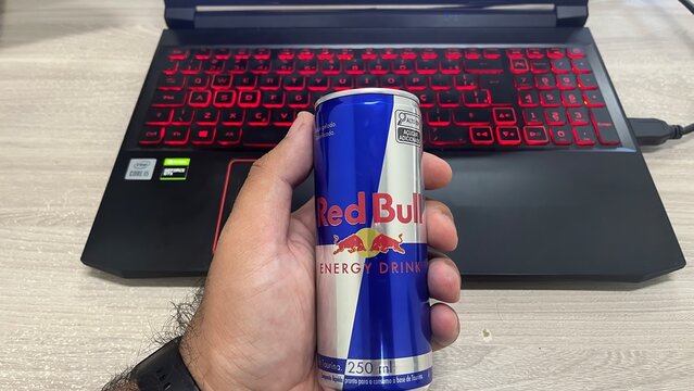 lins, s&atilde;o paulo, brazil. 02.06.2026. A hand holding a Red Bull energy drink can in front of a laptop