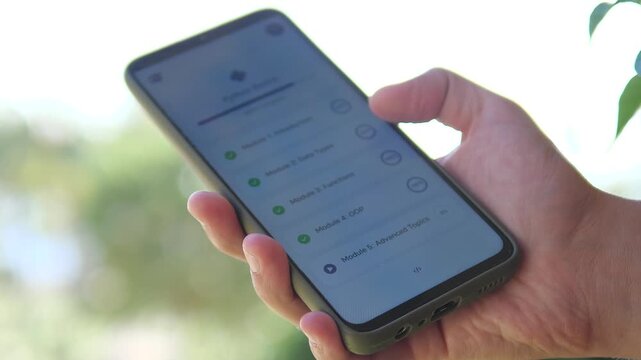 lose-up of a student learning Python programming via a mobile app. User-friendly interface showing course progress and coding modules. Ideal for e-learning, edtech, and modern education marketing.