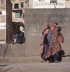 Two veiled Muslim women walking on a Sana street in Yemen