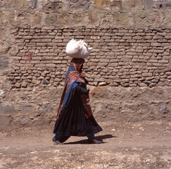 A veiled Muslim woman walks on a Sana a street in Yemen