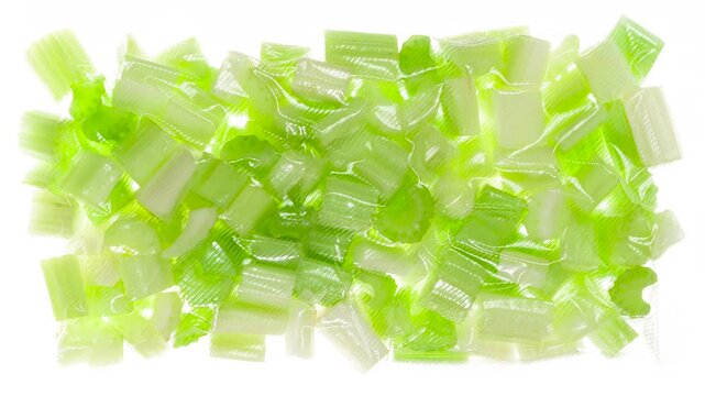 Packaging and Freezing Celery Pieces. Sliced celery stalks are packaged in a vacuum apparatus and subjected to rapid cooling with an ice jet, creating the effect of white steam on a white background