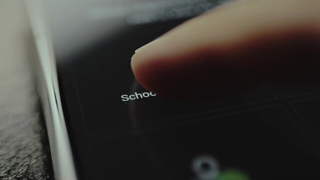 Person taps with finger an icon labeled School University on a digital interface