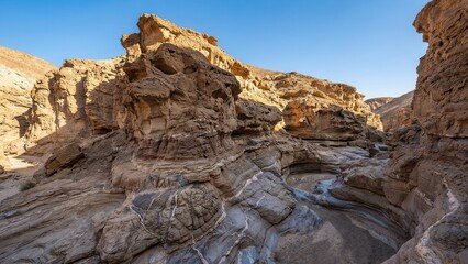 Profound Geological Detail of Sunlit Desert Canyon Formations and Striated Rock Layers