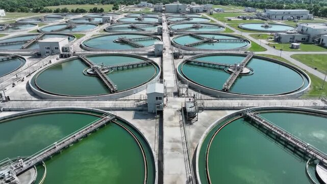 Aerial view of large industrial water treatment plant with multiple circular clarification tanks