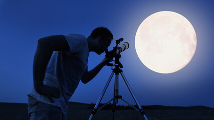 Amateur astronomer using telescope for watching stars, Moon, planets and other celestial objects from a field in nature.