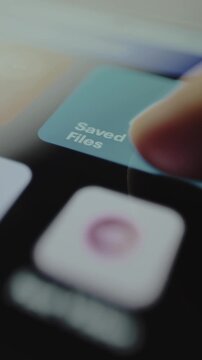 User taps the app button labeled Saved Files