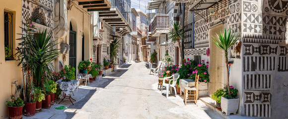 Panoramic View of Pyrgi Village with Traditional Geometric Xysta Wall Paintings and Sunny Empty Street Chios Island Authentic Mediterranean Aesthetic Mastic Villages Greece. high resolution print