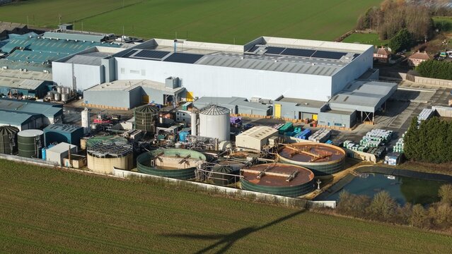 Aerial view of factory buildings with tanks and green fields, Princes Factory, Sutton Bridge, United Kingdom.