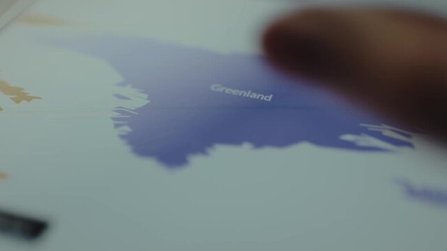 Greenland on the blue digital map, user interacts with the map