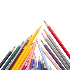 Fototapeta premium Art Supplies Spread out on a White Background With Colored Pencils Arranged in a Triangle Shape