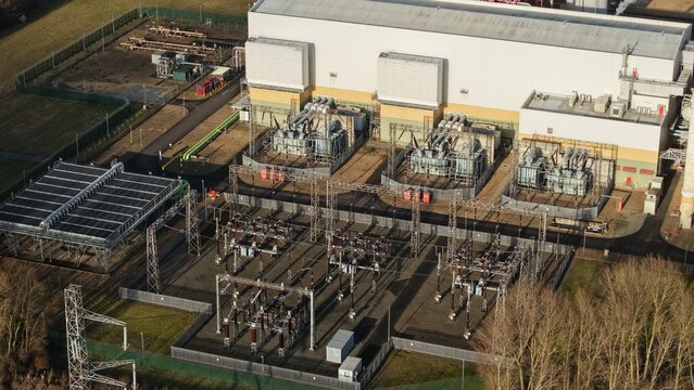 Aerial view of the industrial heart, with transformers and power lines contrasting against the stark architecture, Sutton Bridge, Sutton Bridge, United Kingdom.