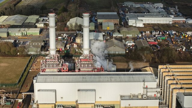 Aerial view of the Sutton Bridge Power Station with its towering chimneys releasing plumes of vapor into the atmosphere, Sutton Bridge, United Kingdom.