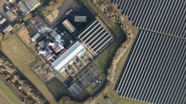 Aerial view of the power station amidst winter's muted tones, juxtaposed against the stark solar array, Sutton Bridge, Sutton Bridge, United Kingdom.
