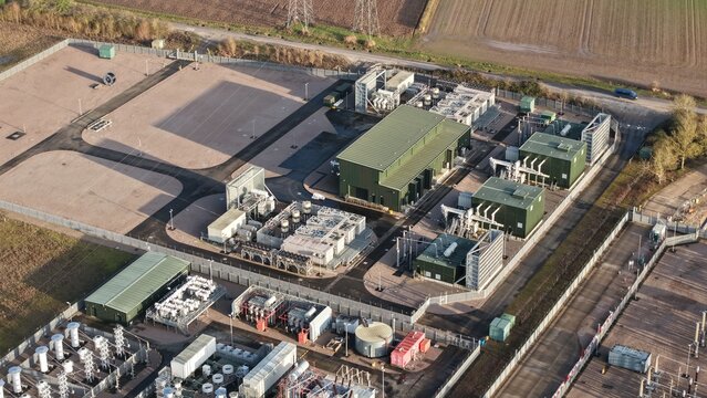 Aerial view of the National Grid Walpole Substation, a complex of green and grey structures against a backdrop of fields, Walpole, Wisbech, United Kingdom.