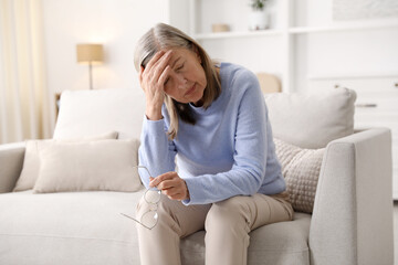 Fototapeta premium Unhappy senior woman feeling fatigue at home