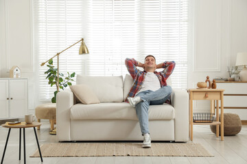 Obraz premium Young man relaxing on sofa at home