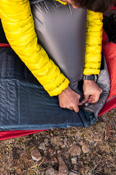 Methodical hiker controlling air valve on sleeping pad