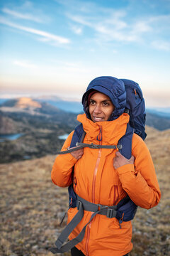 Confident hiker enjoying personal achievement atop quiet mountain ridge