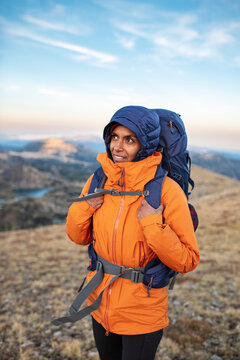 Inspired backpacker feeling deep connection during peaceful mountain moment