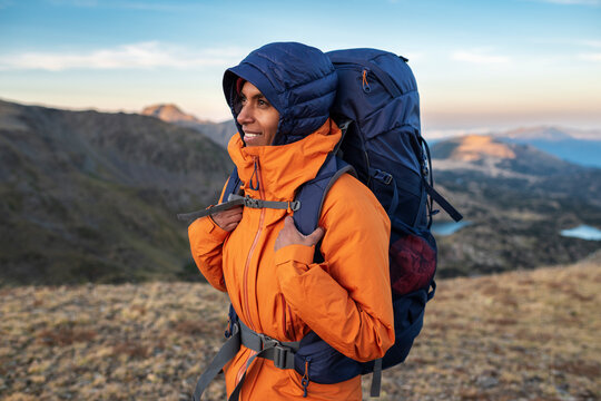 Female hiker wearing technical jacket during cold mountain morning