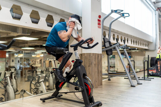 Man with prosthetic leg training on exercise bike