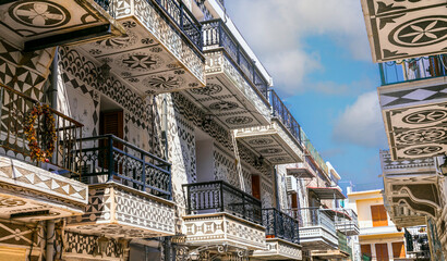 Pyrgi Village Chios: Close-up of Decorative Balconies with Xysta Geometric Patterns, Narrow Alley Perspective with Traditional Painted Architecture, Mastic Island Heritage Greece 4K High Resolution
