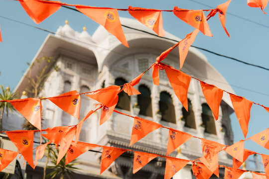 Orange flags on the background of white building in Udaipur, India 