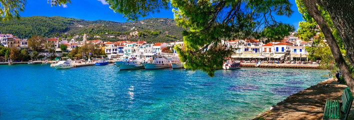 Panoramic 13K View of Skiathos Old Port and Marina from Bourtzi Islet Park under Pine Trees with green bench. Authentic Mediterranean Aesthetic Sporades Islands Greece Travel
