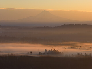 The scenic Mount Hood rises from the forested landscape of northern Oregon. This iconic Pacific Northwest mountain is part of the Cascade Mountain Range.