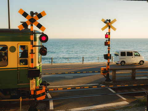 Train on a railway crossing near the sea in Japan 