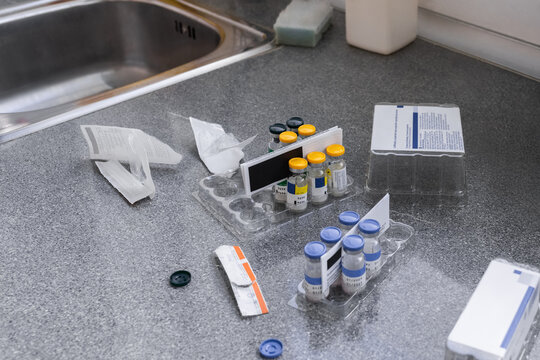 Vials and Medical Supplies on a Countertop in a Clinical Setting