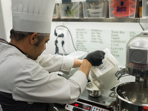 Chef measuring ingredients on professional scales