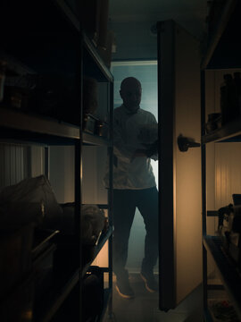 Chef taking ingredients from storage room 