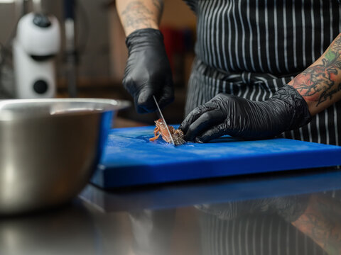 Anonymous chef cutting fish 