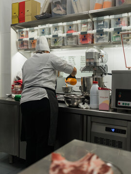 Chef Scaling Ingredients in Busy Kitchen Setting