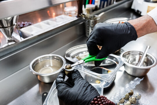 Chef Preparing Quail Eggs in a Modern Kitchen Environment