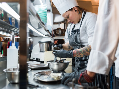 Professional chef preparing sea urchins in kitchen 