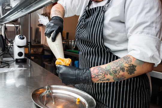 Chef stuffing squash blossom 