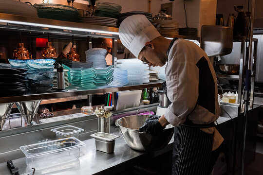 Young cook working at kitchen 