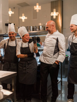 Chefs Celebrating Teamwork in a Modern Kitchen 