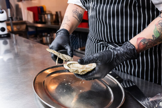 Chef shucking oyster 