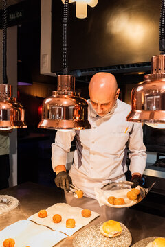 Chef plating croquettes 