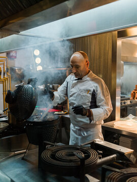 Chef grilling steaks 