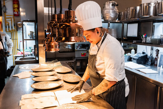 Chef Preparing Dishes in Modern Kitchen 