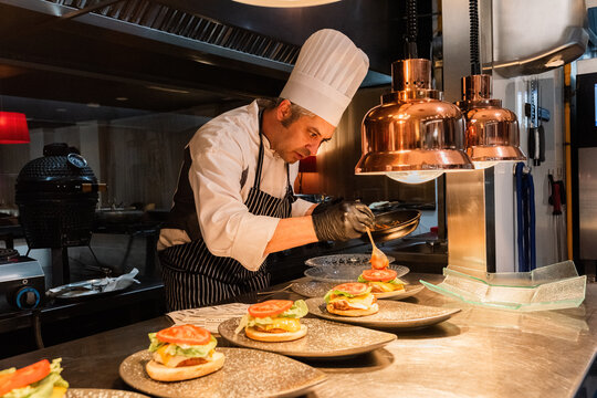 Chef Preparing Gourmet Burgers in a Modern Restaurant Kitchen