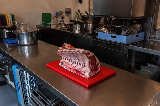 Large cut of meat on kitchen table 
