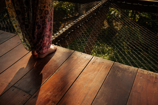 Barefoot mindful moment, serenity on sunlit deck in nature
